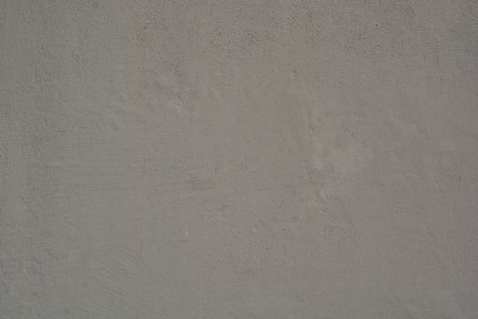 High-resolution image of a gray concrete wall, showcasing rough texture and natural wear.