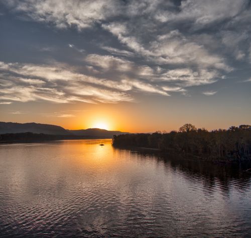 Free Beautiful sunset over a tranquil lake in West Newton, Minnesota, capturing vibrant colors and peaceful water reflections. Stock Photo