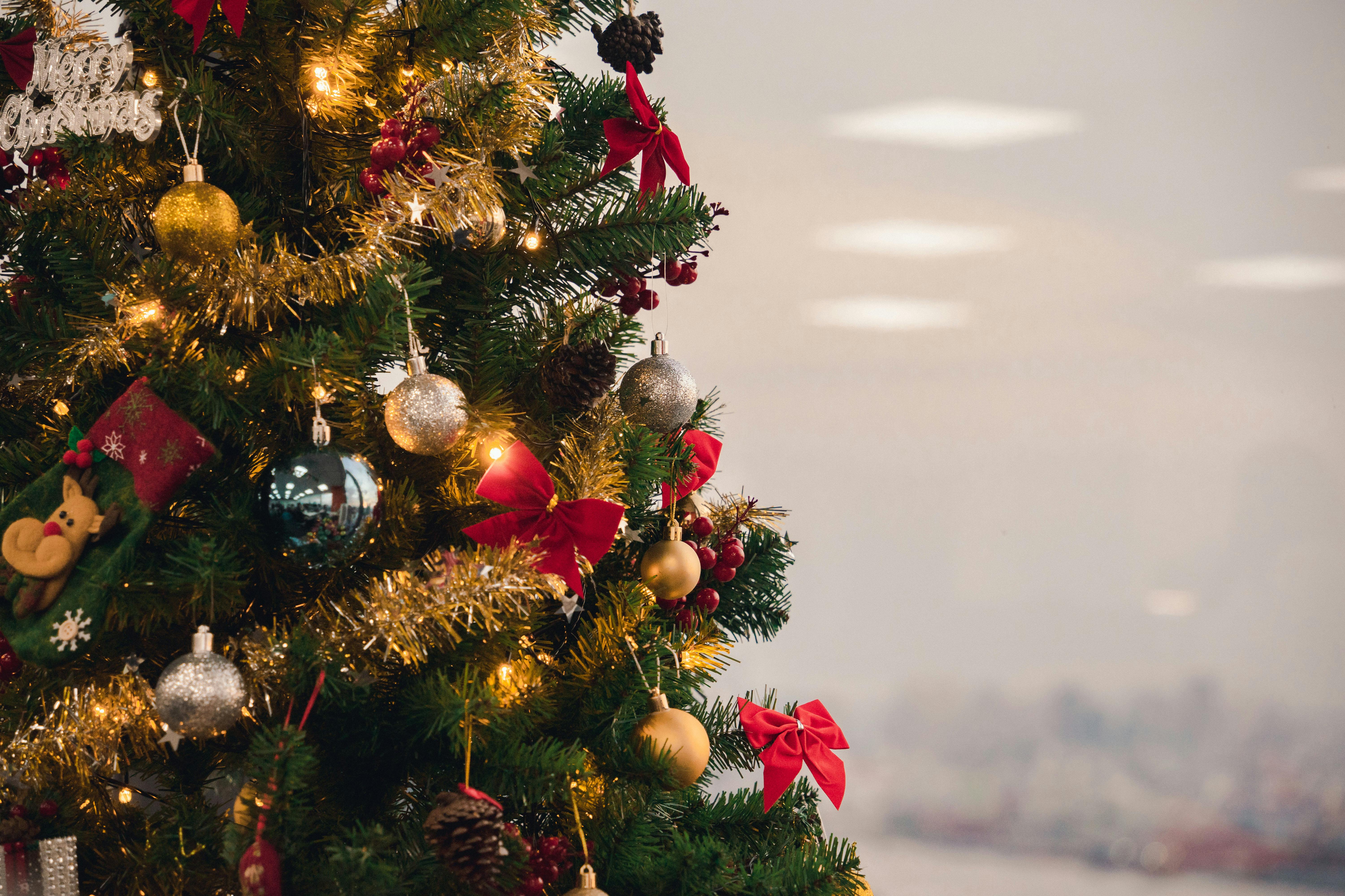 a christmas tree with gold and silver ornaments