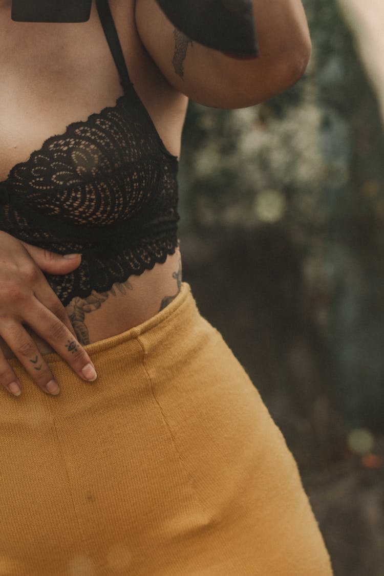 Tattoos On Woman Hand And Body Under Bra