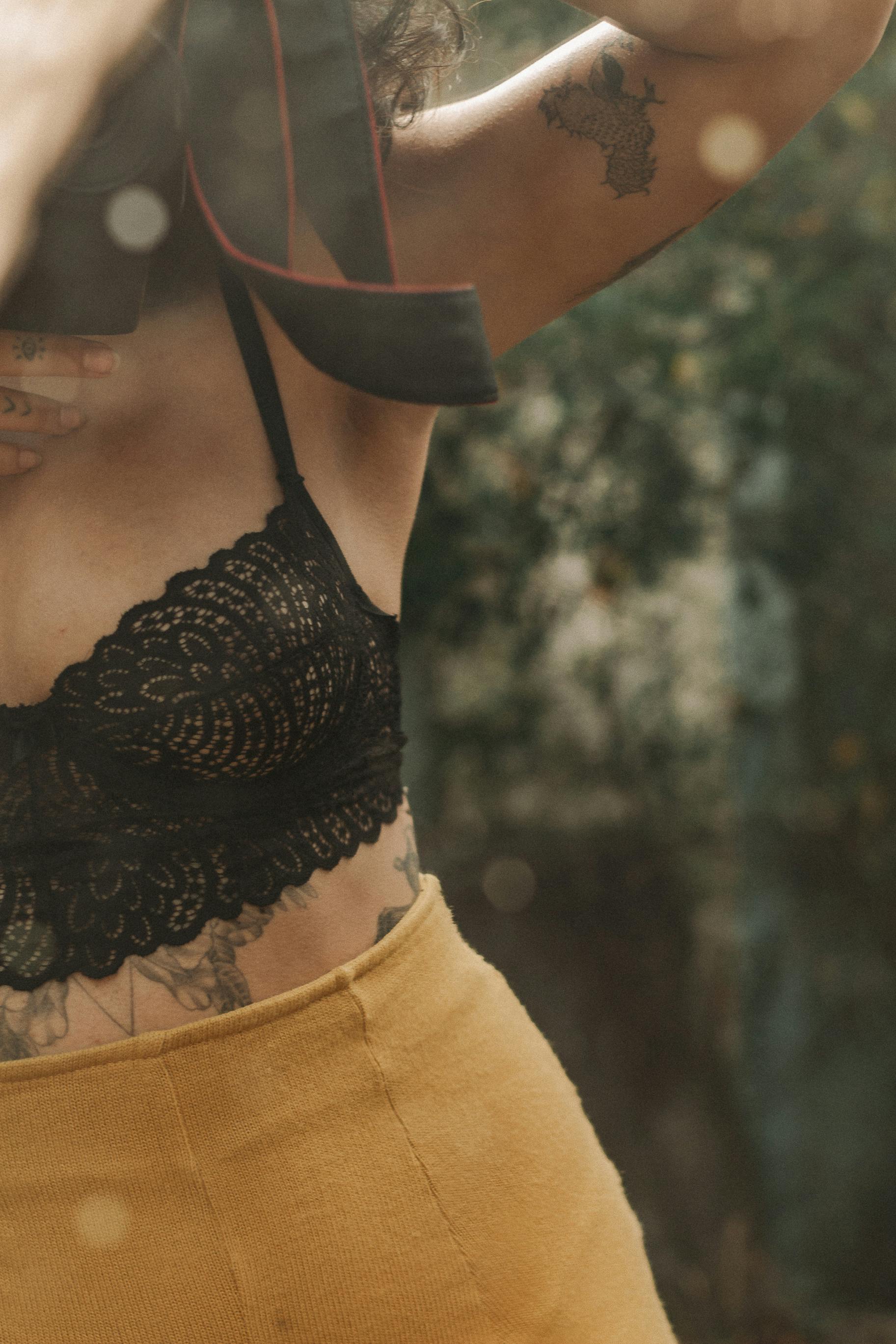 Midsection of a Young Shirtless Woman Wearing a Black Lace Bra · Free Stock  Photo