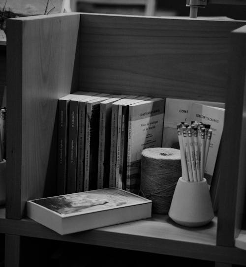 Grayscale Photo of Books and Office Materials