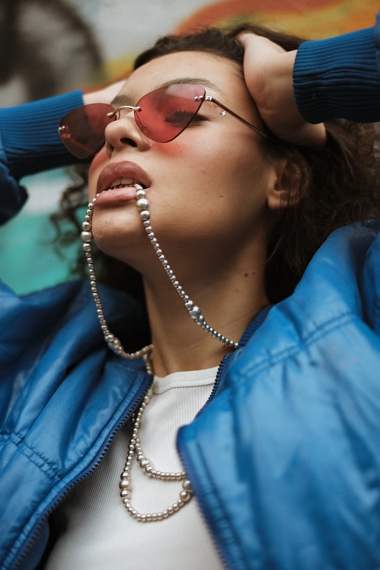 A Woman Biting On A Necklace