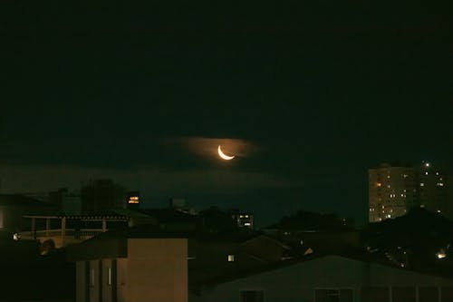 Crescent Moon Over City Buildings 