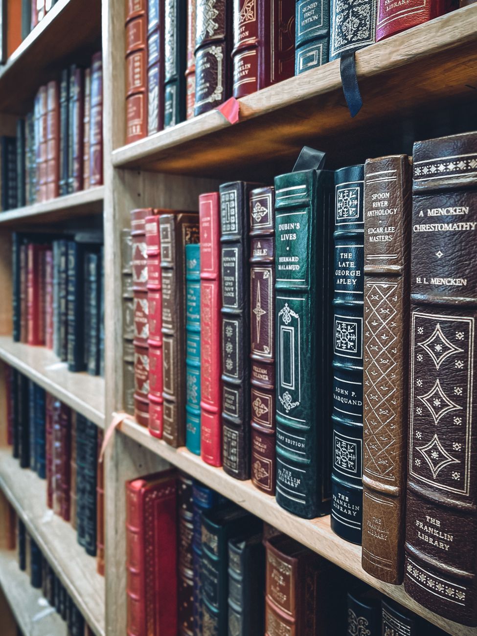 An antique library filled with books and warm lamplight