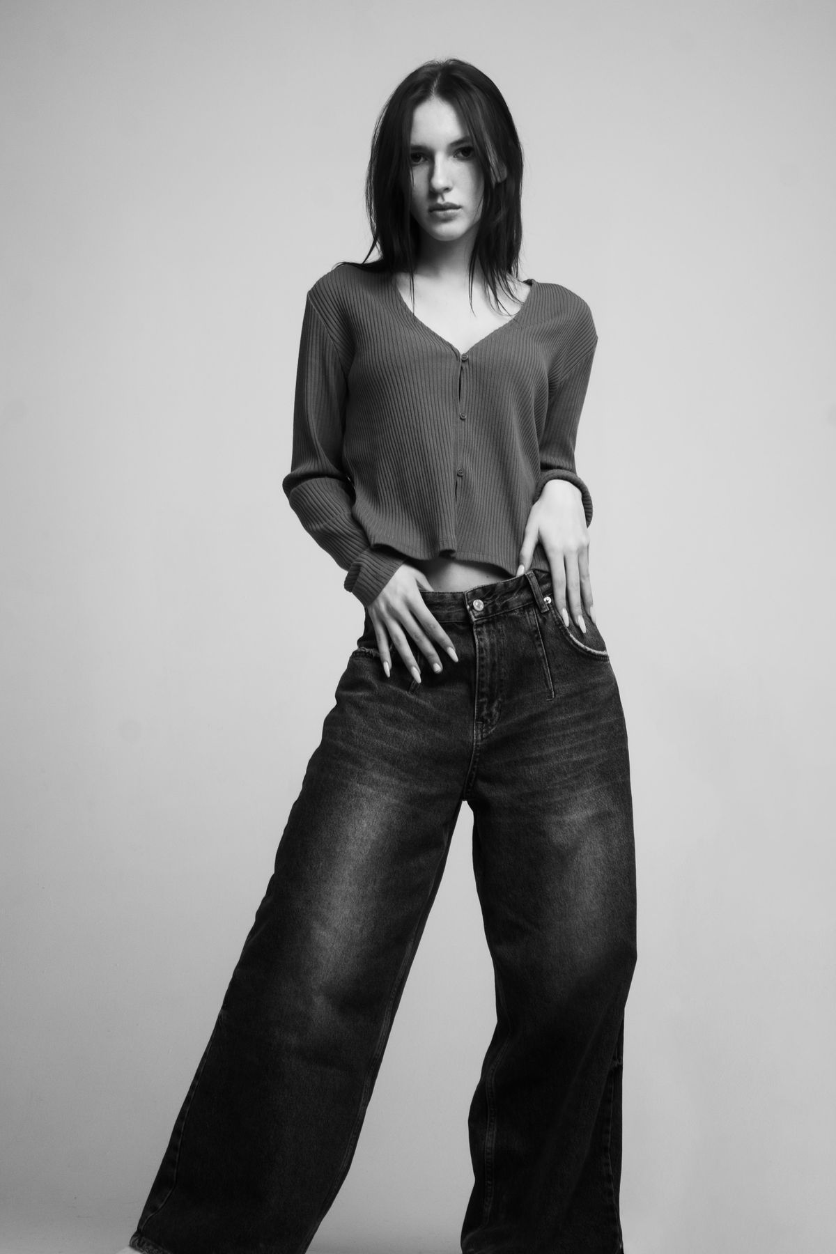 A slim young woman in jeans, black and white — the denim silhouette
