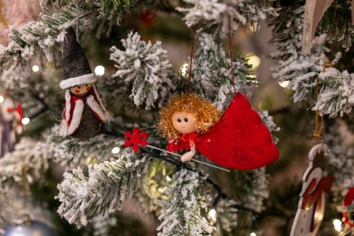Free Charming close-up of snow-dusted Christmas tree with decorative ornaments. Stock Photo