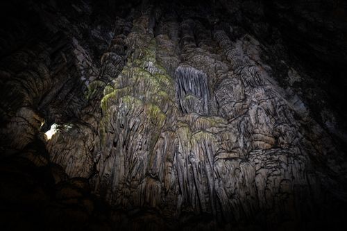 Free A stunning view of stalactites in an illuminated cave, showcasing natural geology. Stock Photo
