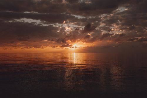 Free Beautiful sunset reflection on the peaceful sea in Manavgat, Antalya, Turkey, with a cloudy sky above. Stock Photo