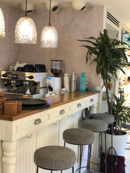 Charming café interior featuring a modern coffee counter and cozy seating.