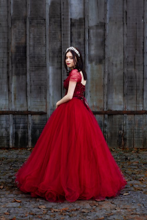 Photo of a Young Woman in a Red Ball Gown