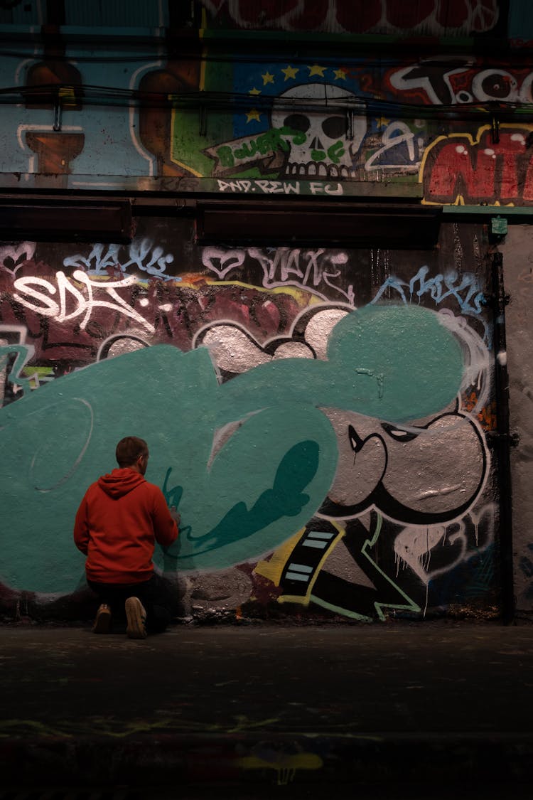 A Man Painting On A Wall 