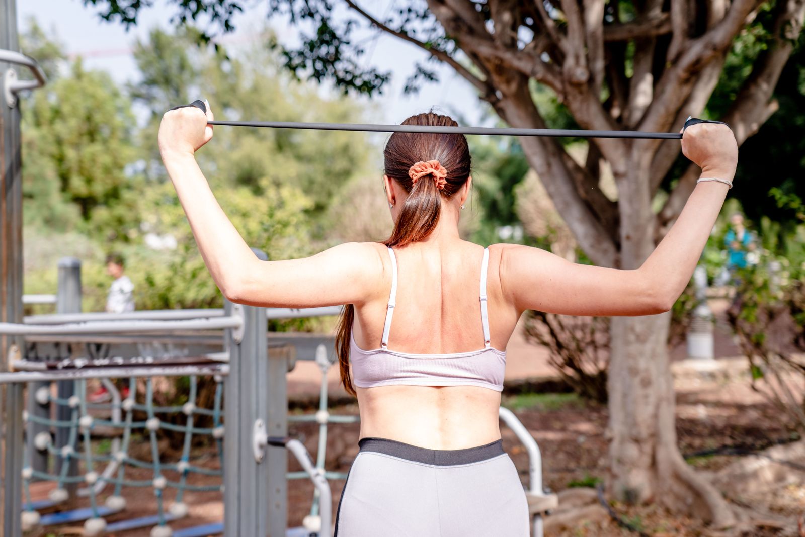 Woman using a resistance band during a controlled outdoor strength workout