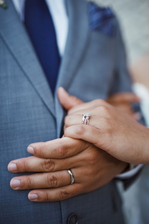 Free Close-up of bride and groom's hands showing wedding rings, symbolizing love and commitment. Stock Photo
