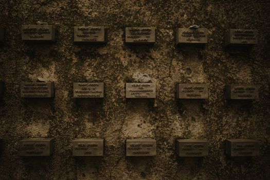 Wall of memorial plaques symbolizing remembrance of historical events.
