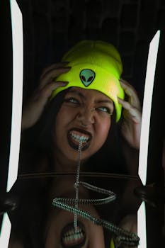 A striking portrait of a woman with an alien beanie and chain reflection, showcasing unique expression.