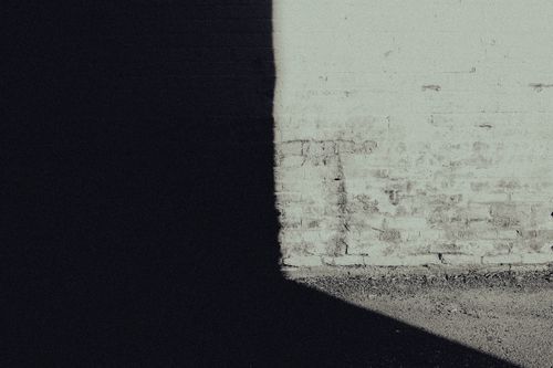 Free Intriguing play of light and shadow on a brick wall, creating a dramatic visual effect. Stock Photo