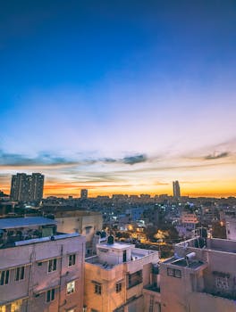 Stunning sunset over urban skyline, showcasing vibrant colors and cityscape.