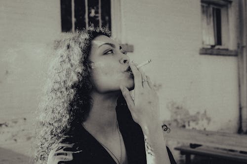 Woman Smoking Cigarette in Black and White