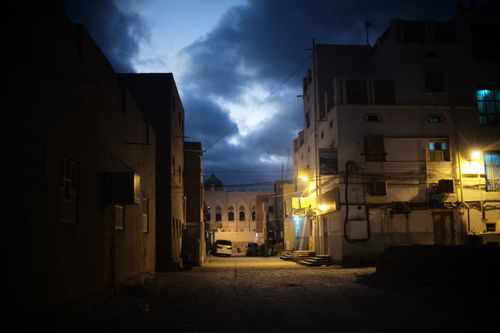 Free Peaceful evening street scene in Tarim, showing traditional architecture under a cloudy sky. Stock Photo