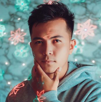 Portrait of a young man with creative face projections in a dreamy setting, evoking thought and creativity.
