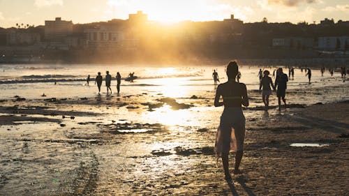 Photo of People on the Beach during Sunset