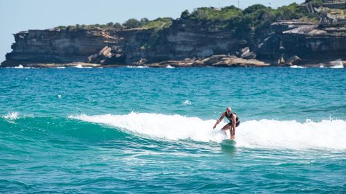 Free A surfer rides the waves at Bondi Beach, a famous surfing destination in Australia. Stock Photo
