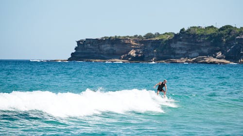 A Man Surfing on the Sea  