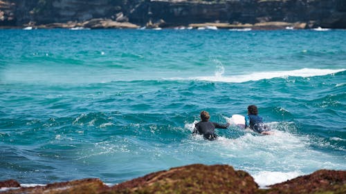 Men Surfing Together 