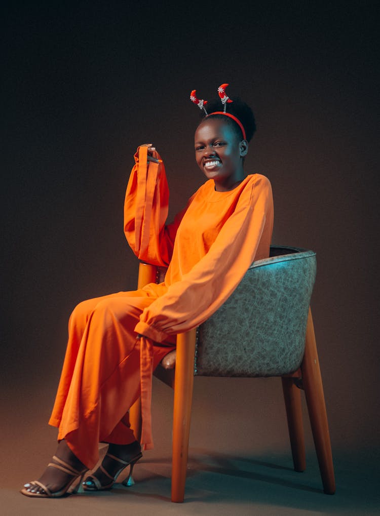 Smiling Woman With Hair Hoop Posing In Studio