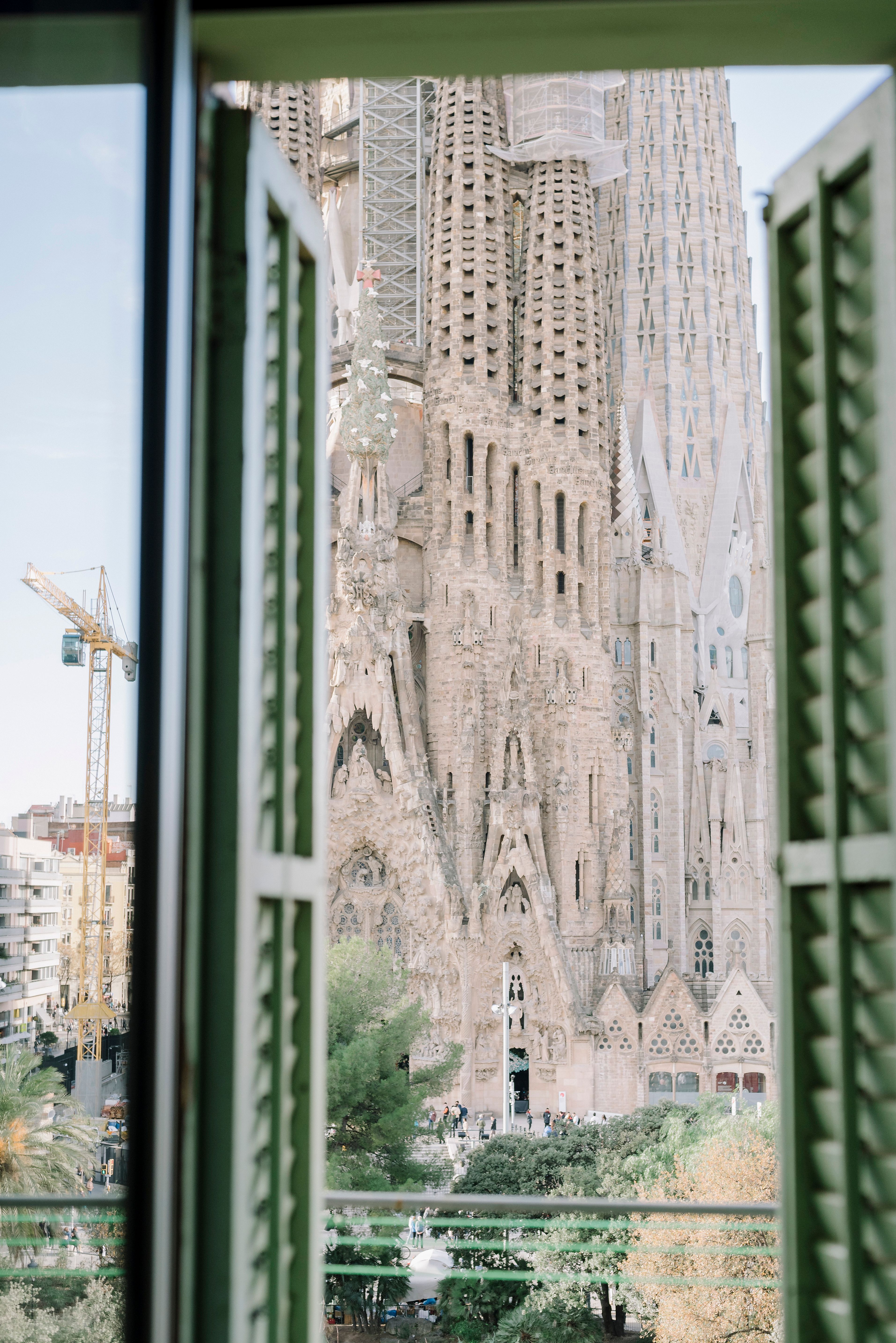 Unique perspective of Sagrada Familia through a window in Barcelona, Spain.