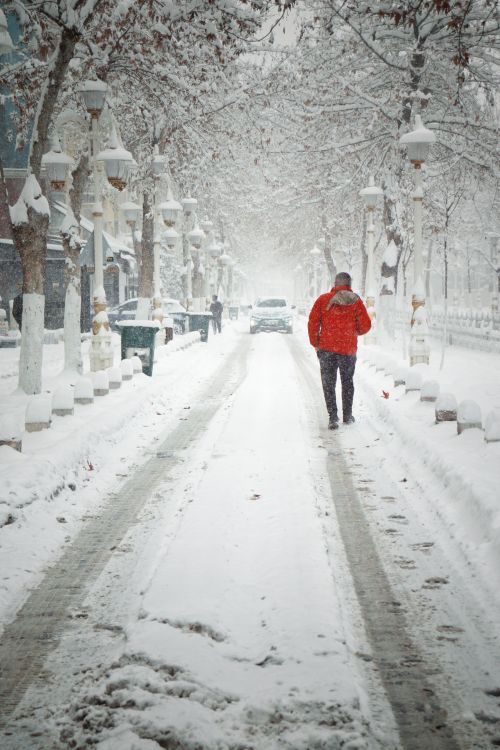 Free Person walking on a snow-covered street in Malatya, Turkey during winter. Stock Photo