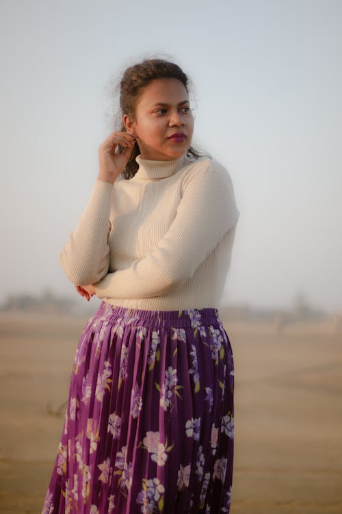 Woman in White Sweater and Floral Skirt