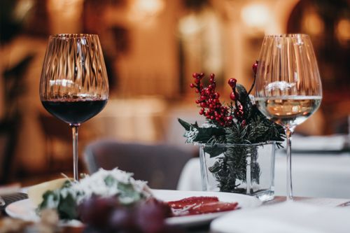 Free Elegant table setting with wine glasses and festive decorations, perfect for holiday dining. Stock Photo