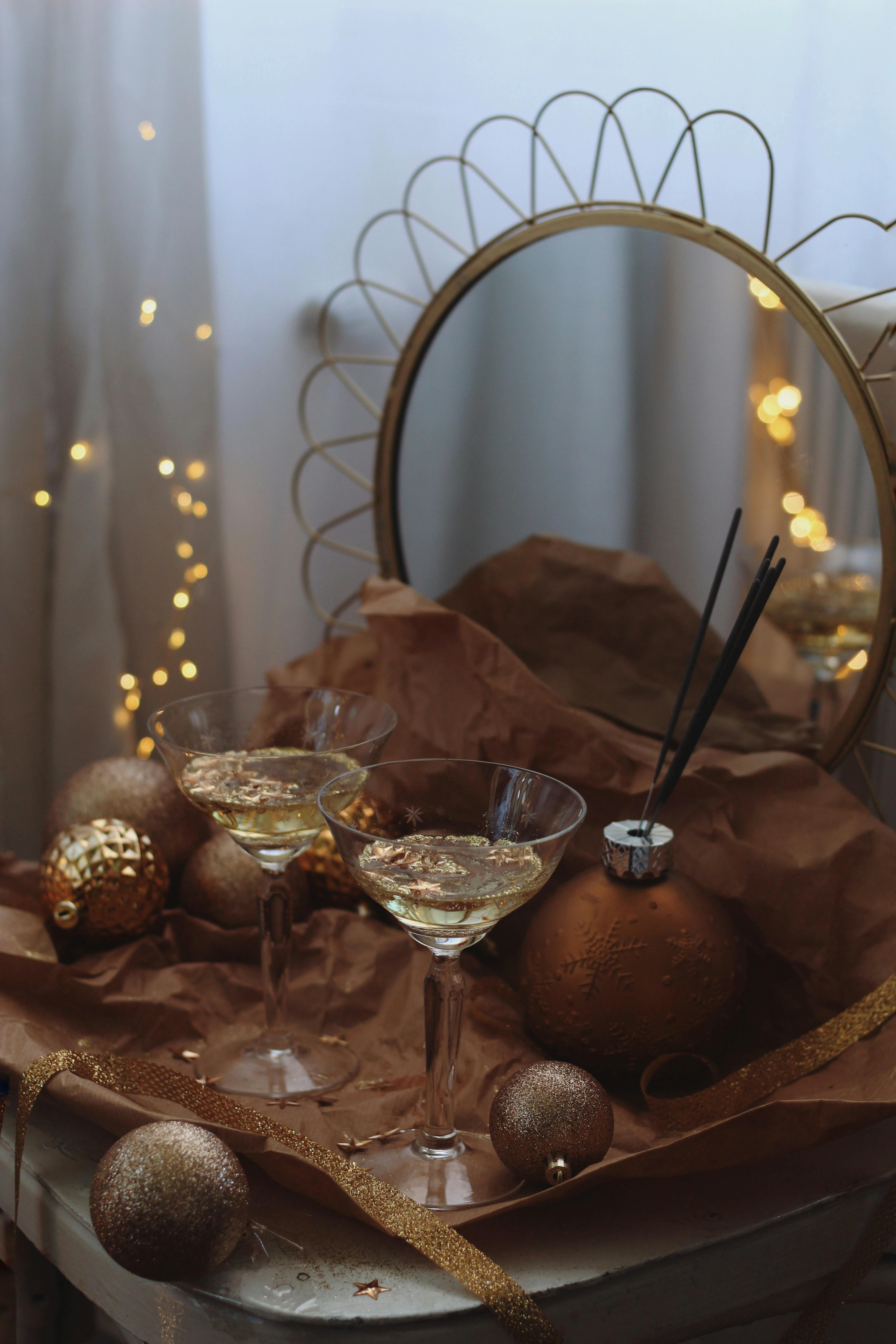 Festive scene featuring champagne glasses and golden holiday decorations, perfect for celebrations.