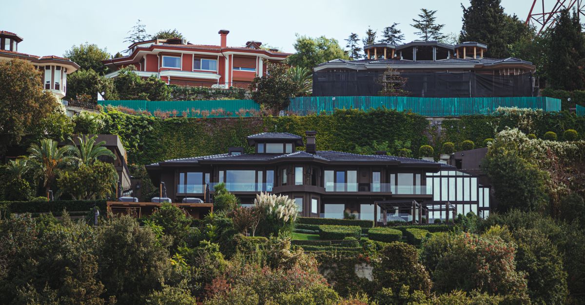 Stunning view of luxurious mansions surrounded by lush vegetation with a modern architectural design.