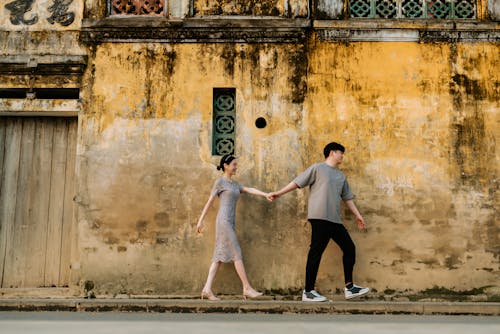 Photo of Couple Walking on Sidewalk
