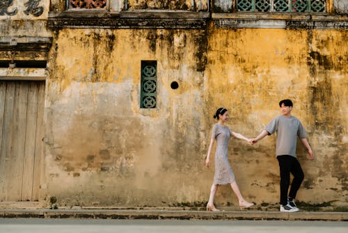 Man Walking on Sidewalk with a Woman