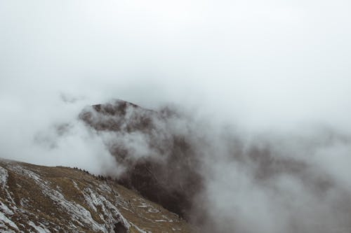 Free Thick Clouds Obscuring Mountain Peak Stock Photo