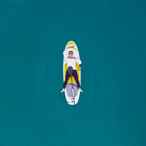 Drone Shot of a Man on a Paddleboard