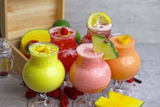 Vibrant smoothies in glasses with fresh fruit garnishes, promoting a healthy lifestyle.