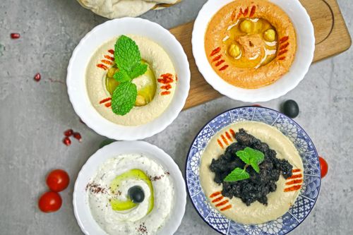 Free A delicious selection of Middle Eastern dips served in bowls, perfect for healthy eating. Stock Photo