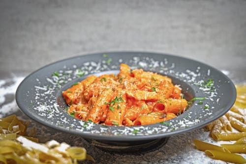 A plate of pasta with sauce and cheese