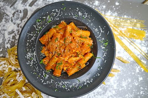 Free A mouthwatering dish of rigatoni pasta coated in rich tomato sauce with herbs and cheese. Stock Photo