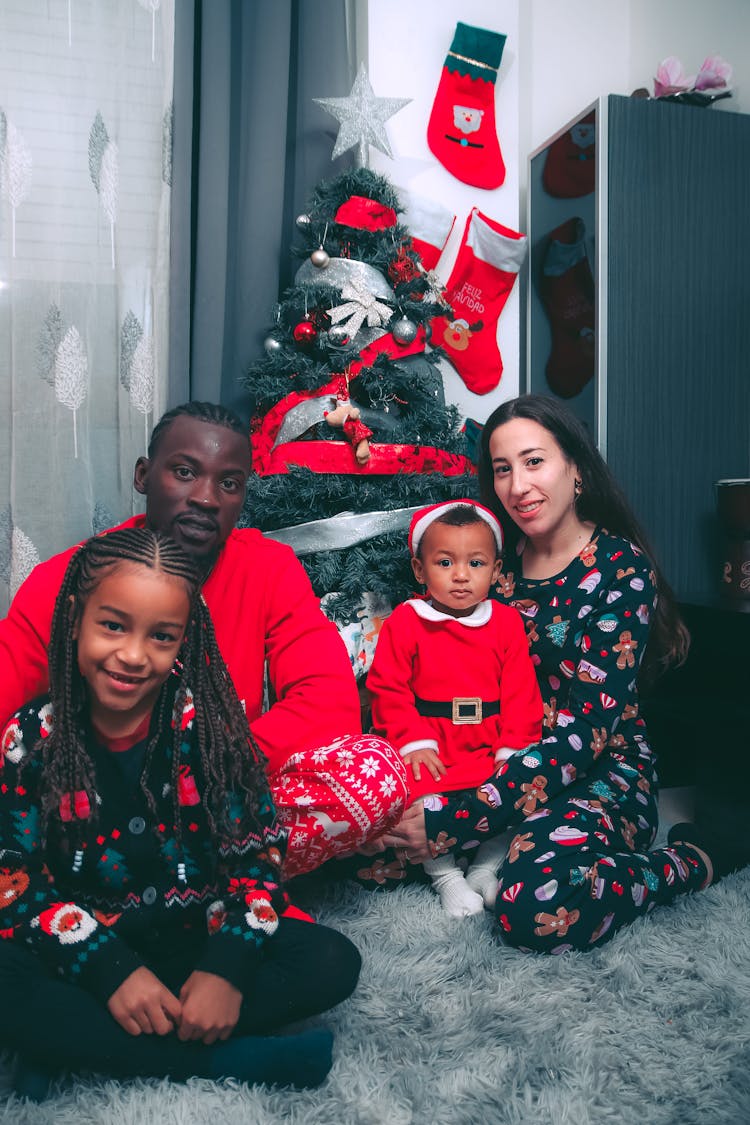 Family Sitting Near Christmas Tree