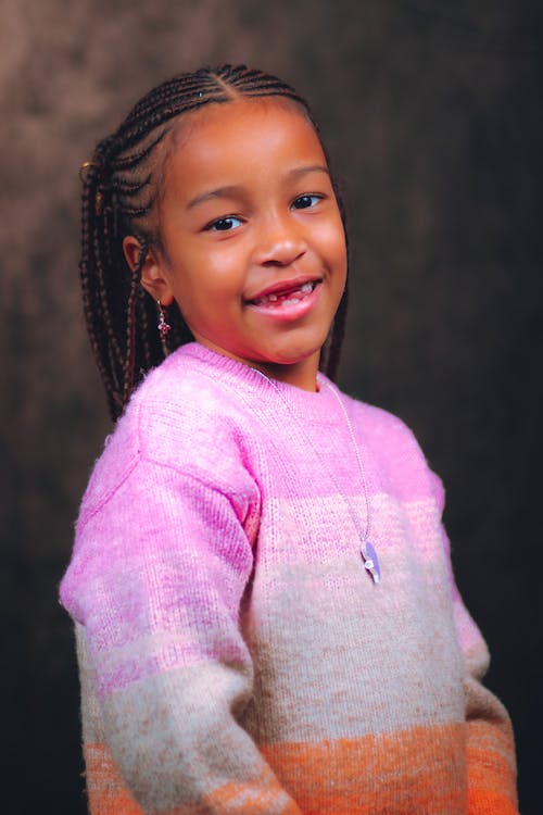 Young Girl Wearing a Knitted Sweater Smiling
