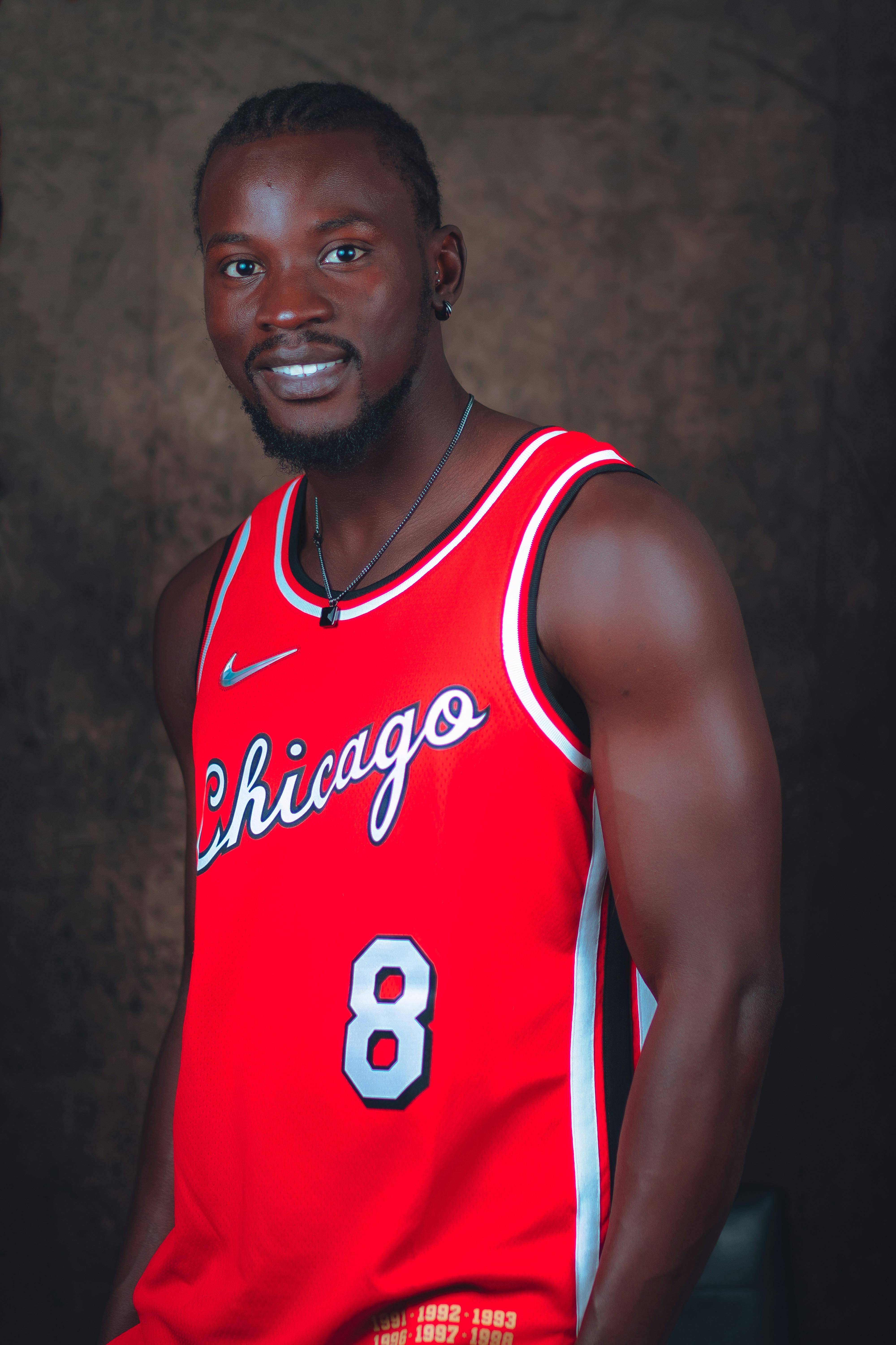 a man in red shirt wearing necklace