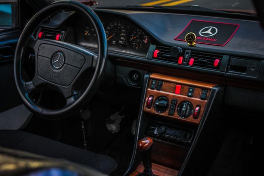 Close-up of classic Mercedes car interior highlighting the steering wheel and dashboard.