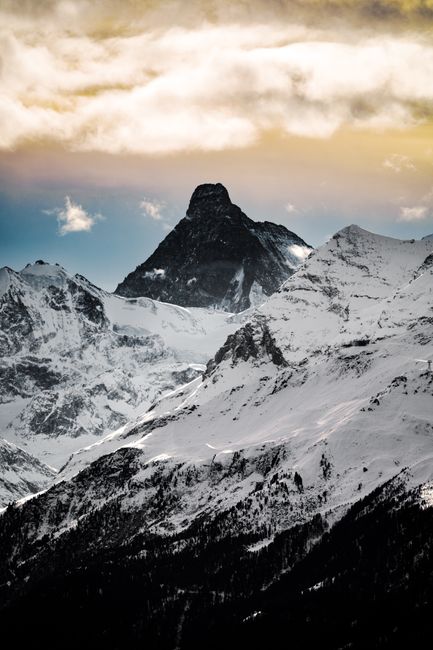 Stunning view of snow-covered mountains in Crans-Montana, Switzerland at sunset.