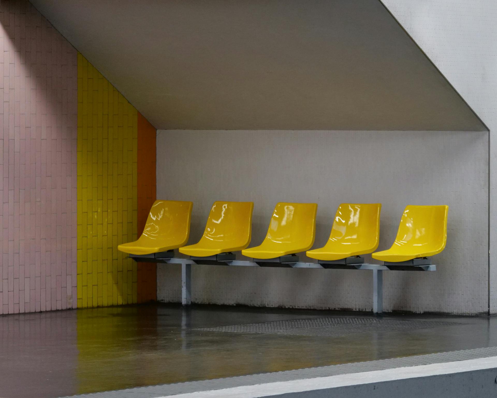 Yellow Plastic Chairs in Row for Waiting